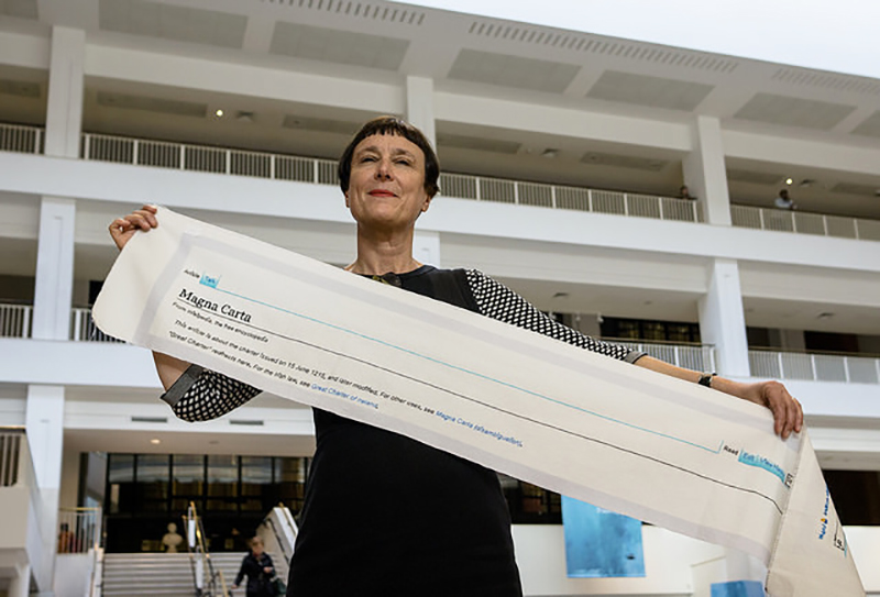 Cornelia Parker holding part of 'Magna Carta (An Embroidery)'